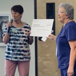Dodie Lopez, Charity Co-Chair presents check to Lynn Crawford, HOPE Dementia Support Program Manager